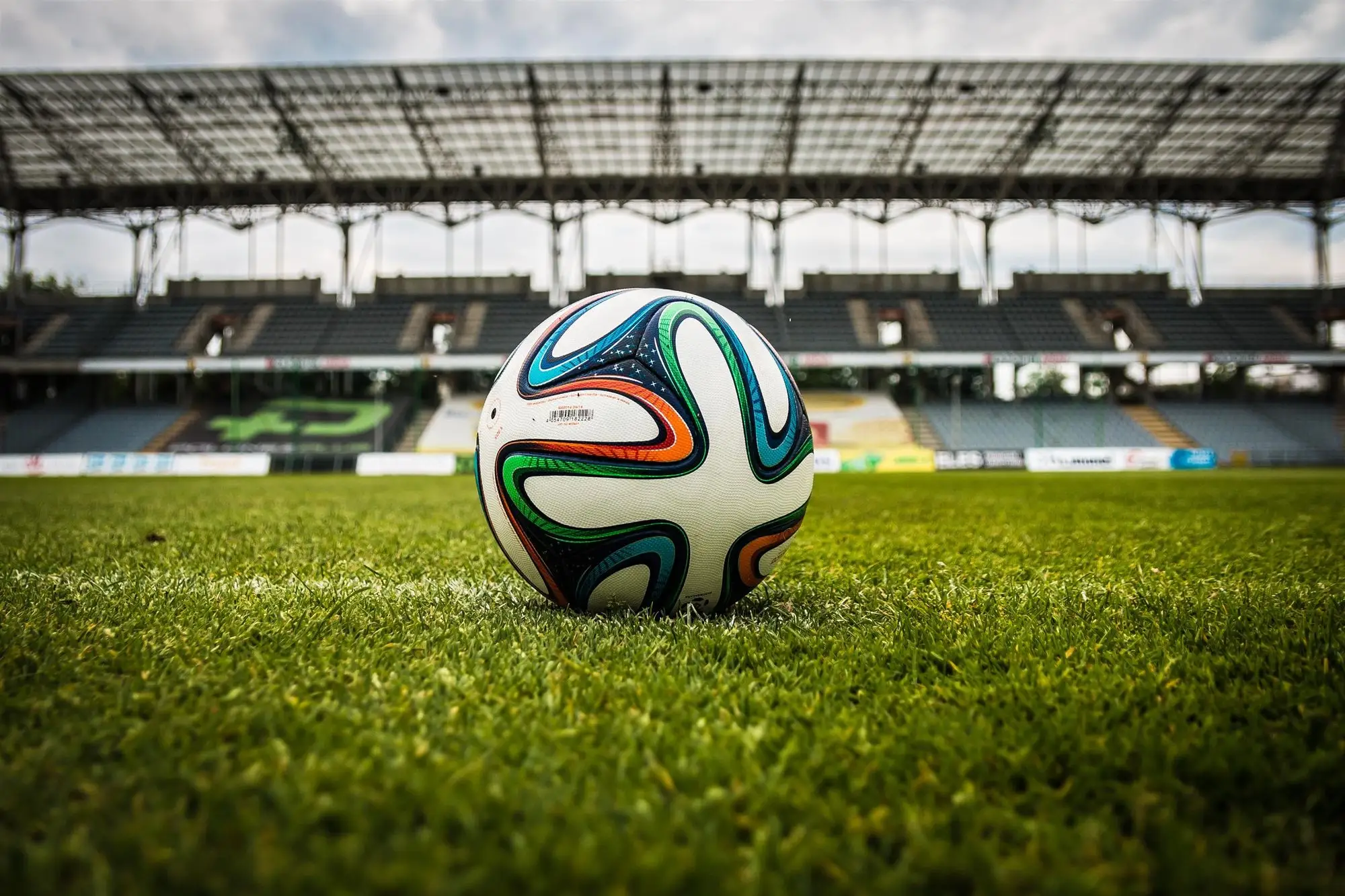 Balón de fútbol sobre el césped de un estadio